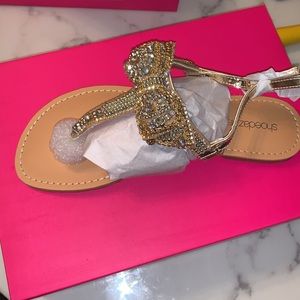 Gold bow sandals.